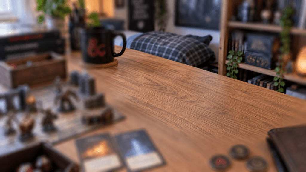 Tabletop gaming table setup with character miniatures, cards, and dice